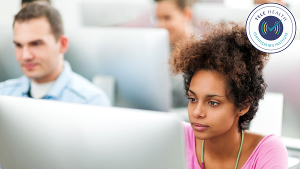 Woman and a man in front of monitor in computer lab classroom