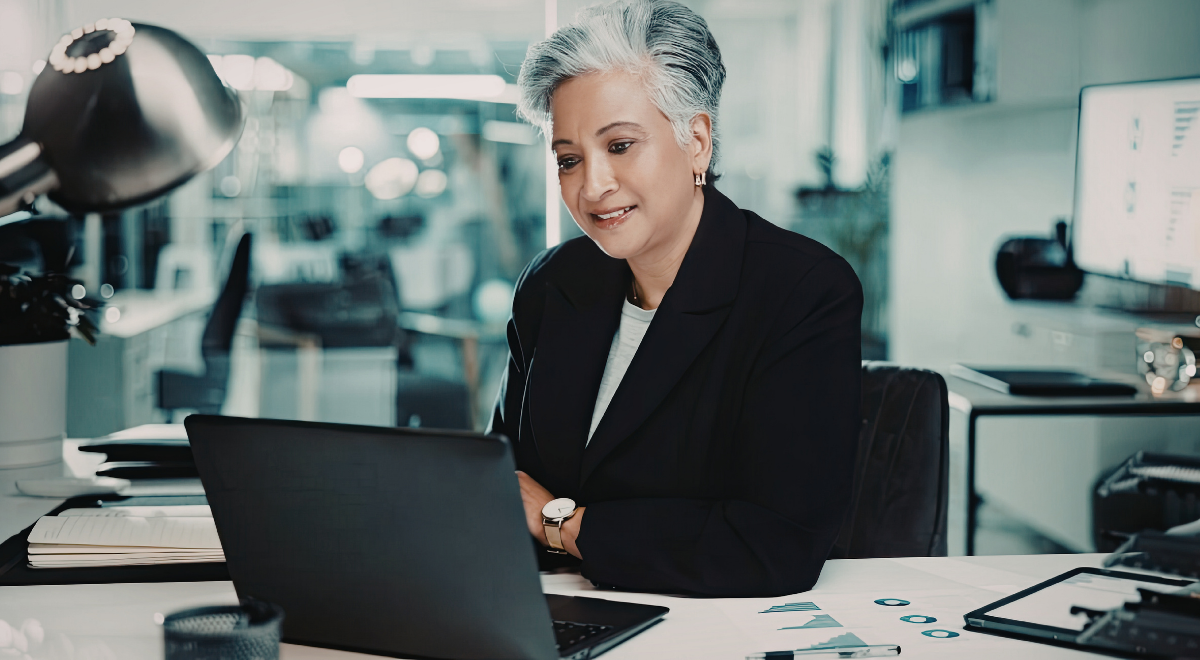 woman working at desk using laptop computer