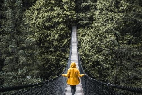 Person crossing suspended bridge connecting interstate