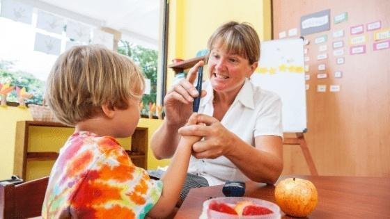 Female School nurse in Telehealth Training with young male student