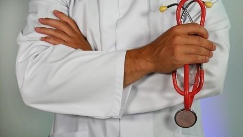 Clinician standing with hands folded