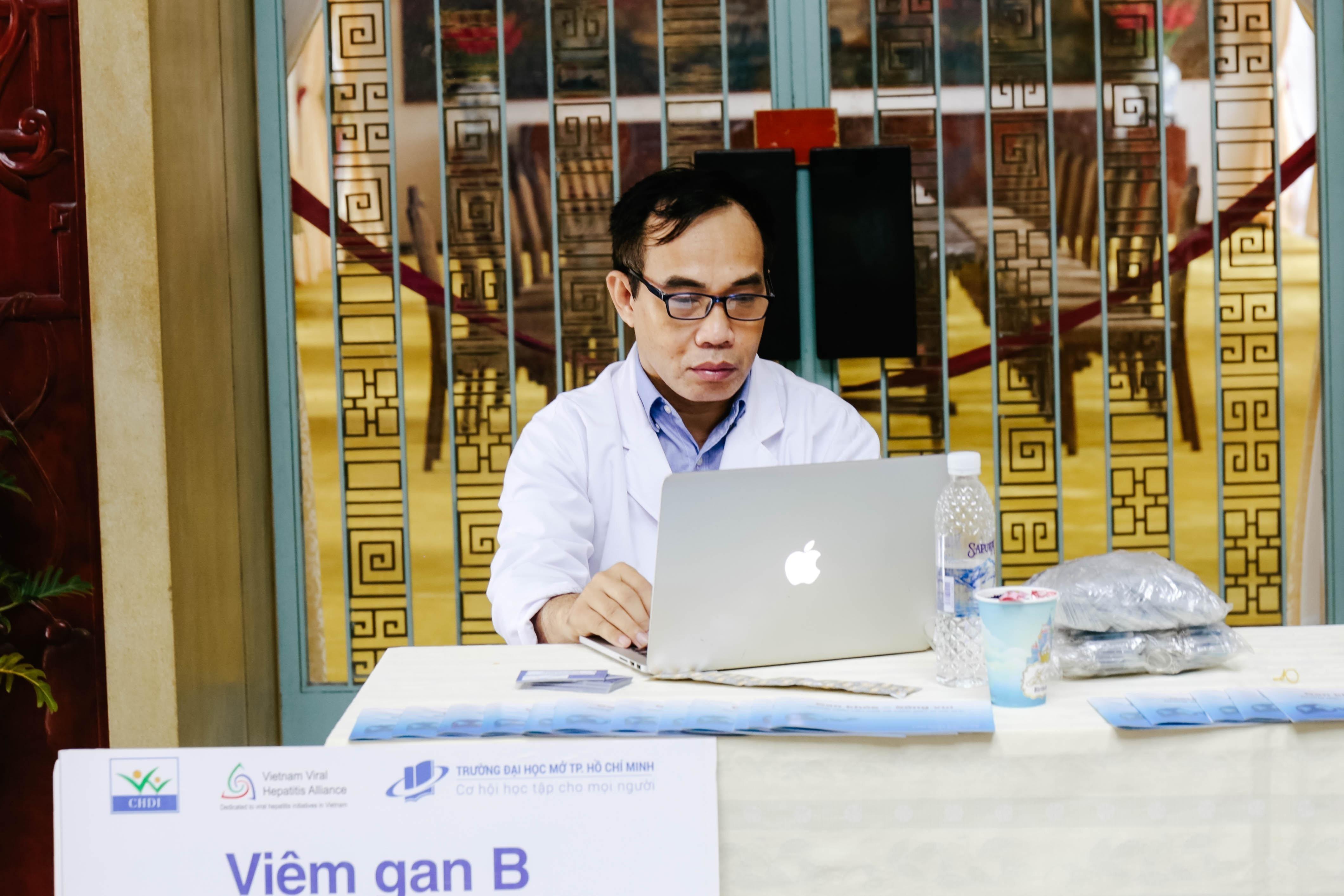 Health Practicioner on his computer reviewing Telemedicine Guidelines  