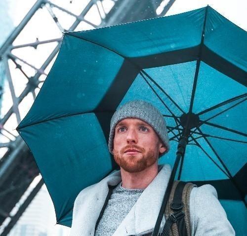 Man under umbrella representing Professional Liability Insurance for Telemental Health Providers 