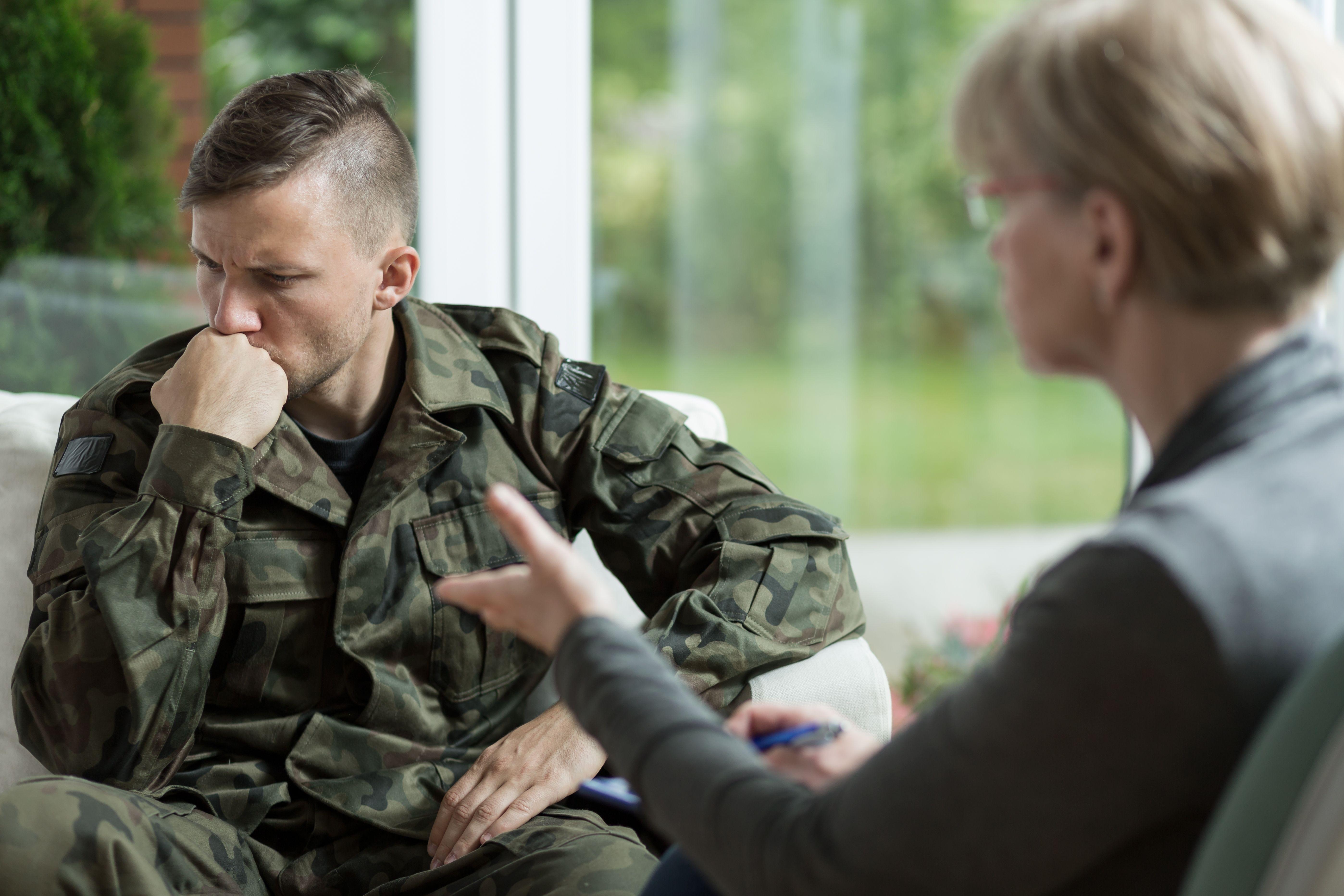 Male army veteran in support session with female clinician